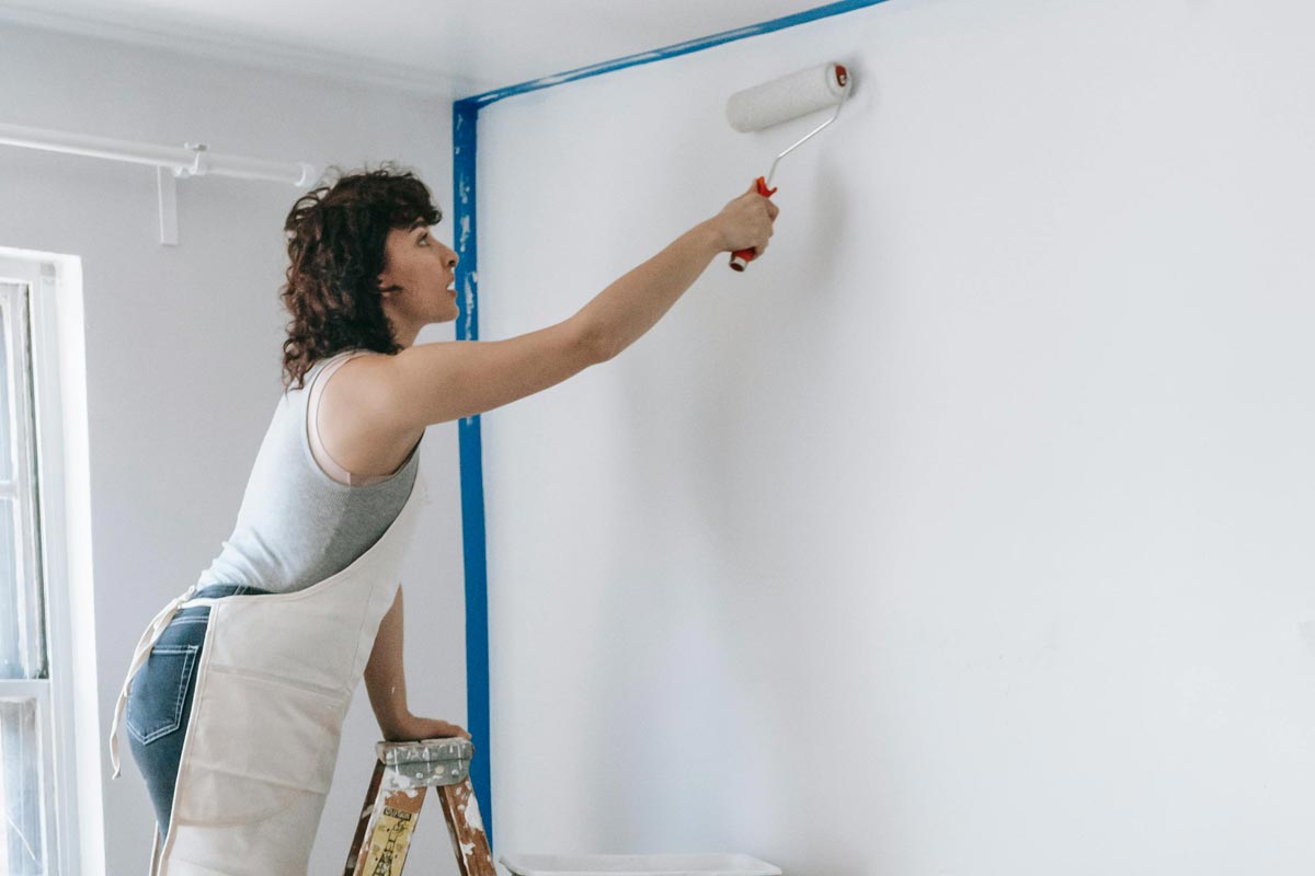Woman painting a wall